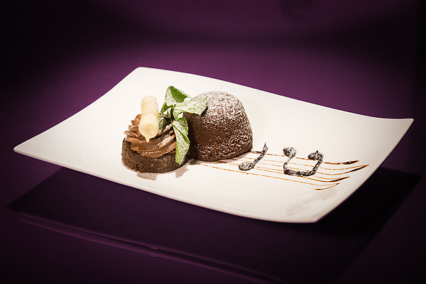 A piece of cake on a pink glass table